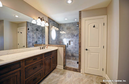 Recessed lighting and tiled walk-in shower in the master bathroom. The Barclay plan 248.