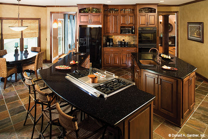 Prep island and separate bar seating island in the kitchen. The Amherst plan 753.