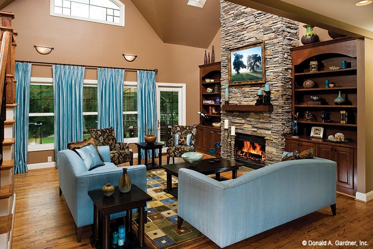 Floor to ceiling stone fireplace in the living room. The Amherst plan 753.