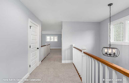 Well-lit hallway with banister to overlook the lower level. Applecross plan 1501