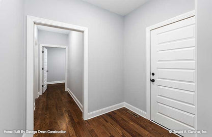 Hallway with wood floors and molding around the entryway. Applecross plan 1501