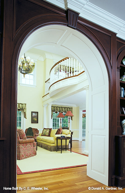 Wood-stained arched doorway to the great room. The Arbordale plan 452.