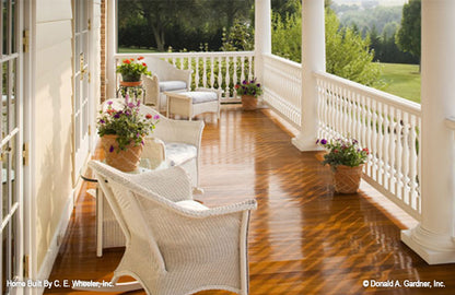 Elegant wicker seating on the rear covered porch. The Arbordale plan 452.