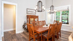 An open dining room gives space for both formal and casual dining for one story house plan 1506 The Ashbry