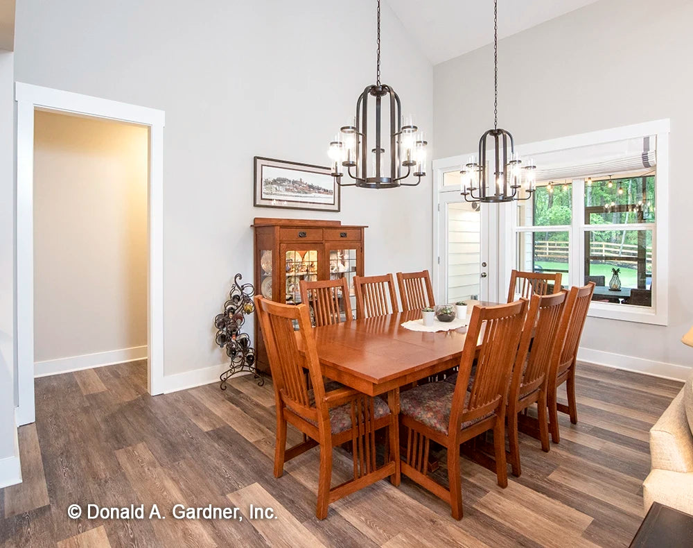 An open dining room gives space for both formal and casual dining for one story house plan 1506 The Ashbry