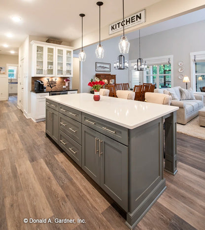 The center island provides extra counter and prep space  for simple house plan 1506 The Ashbry