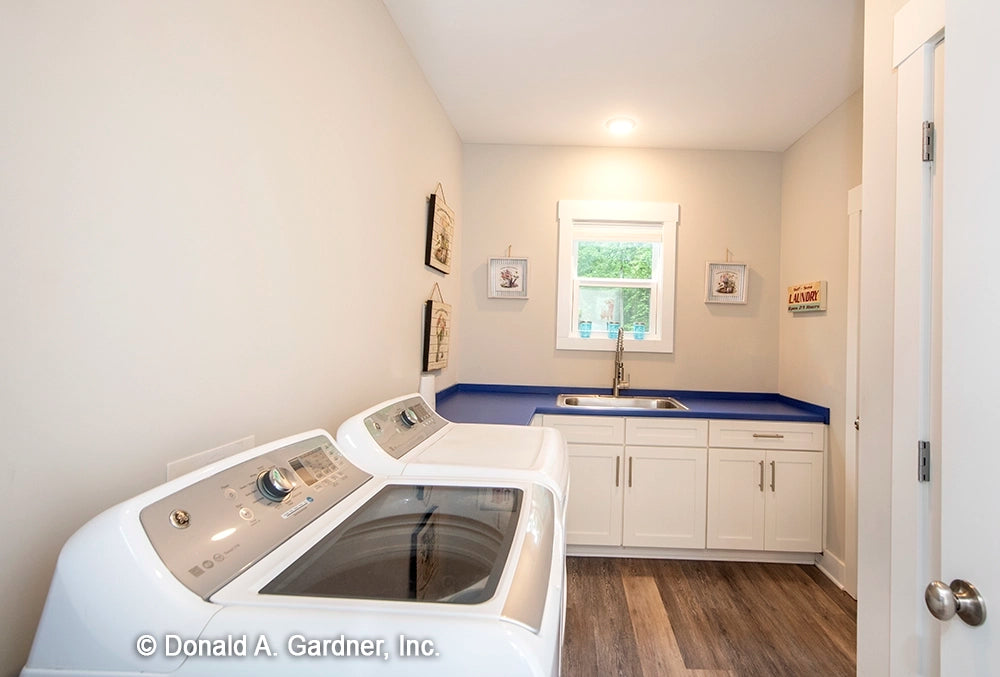 Plenty of storage and counter space in the utility room in simple house plan 1506 The Ashbry