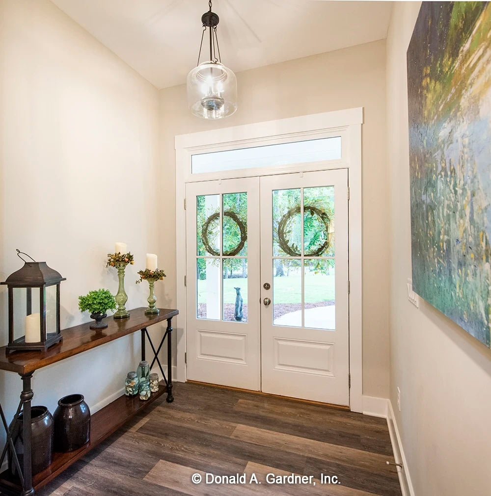 The foyer makes the first impression for visitors to one story house plan 1506 The Ashbry