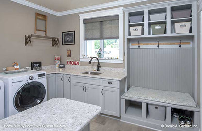 Plenty of storage and counter space in the utility room in ranch house plan 1409 The Austin