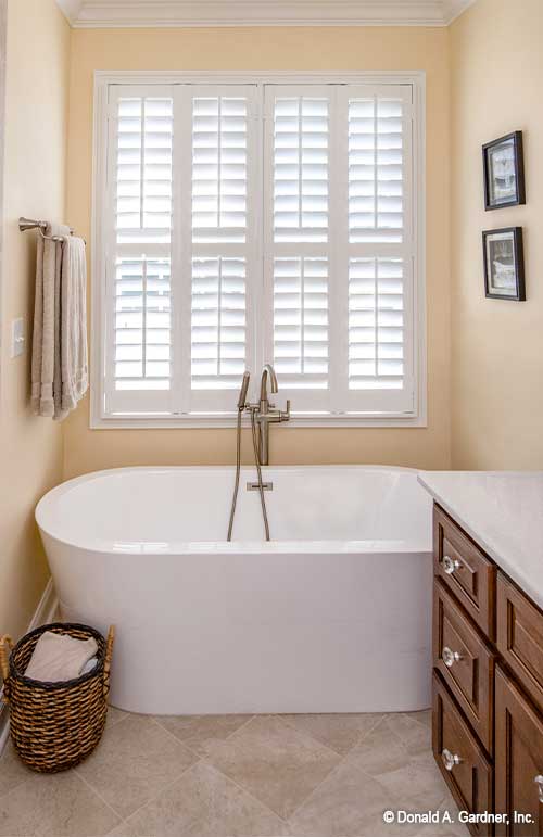 Large window behind the soaking tub in the master bathroom. The Avant plan 1346.