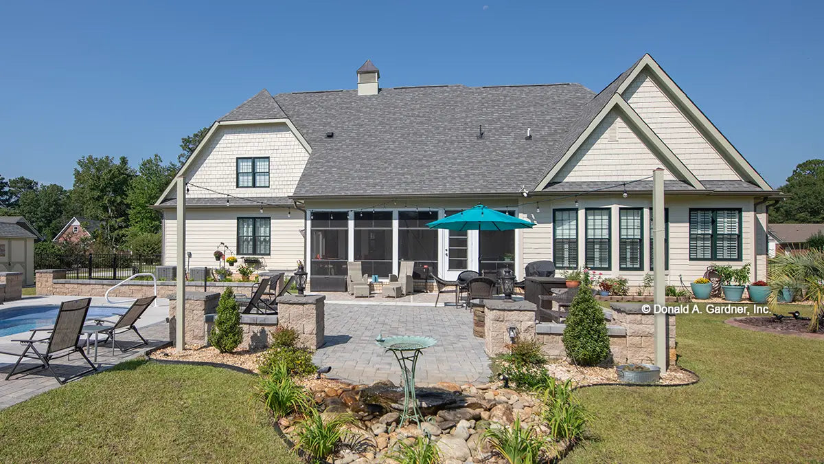 Rear view photograph screened in porch and pool. The Avant plan 1346.