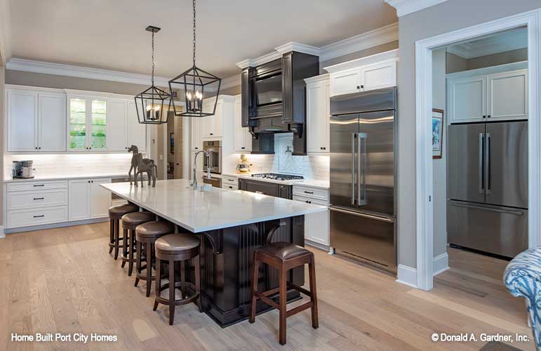 Full kitchen view with large island and stainless steel appliances.. The Barlett plan 1372. 