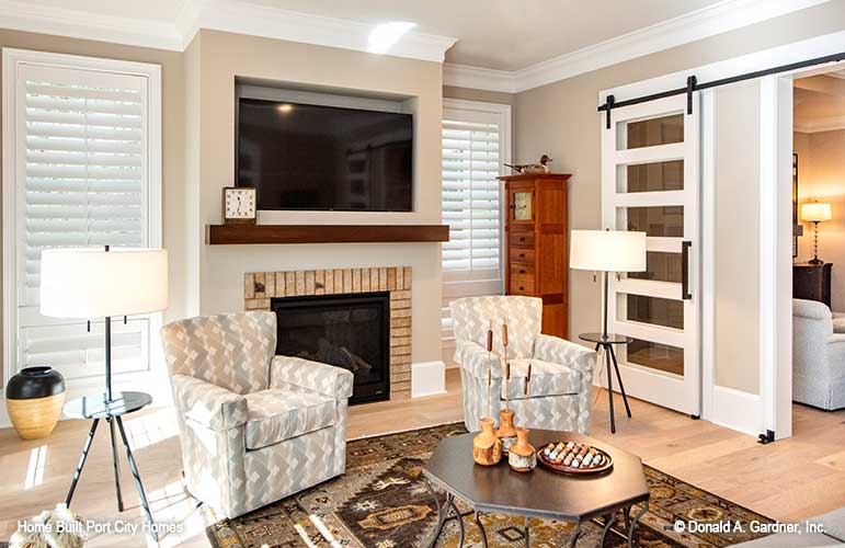 Sitting room with fireplace and tv. The Barlett plan 1372. 