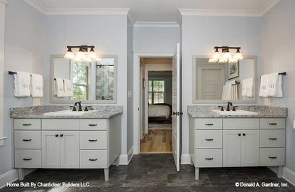 Two separate vanities on either side of entry in the master bathroom. The Baskerville plan 1312.