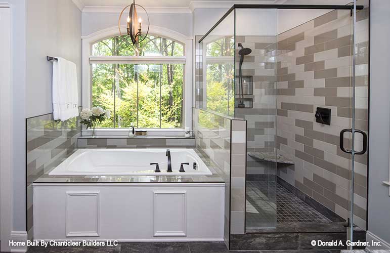 Tiled walk-in shower next to the soaking tub in the master bathroom. The Baskerville plan 1312.