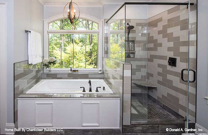 Tiled walk-in shower next to the soaking tub in the master bathroom. The Baskerville plan 1312.