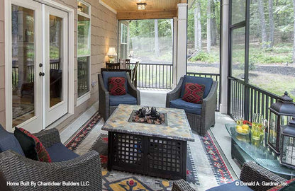 Seating and fire pit in the screened in porch. The Baskerville plan 1312.