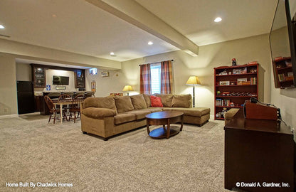 Entertainment room with recessed lighting. The Beauxville plan 1236.