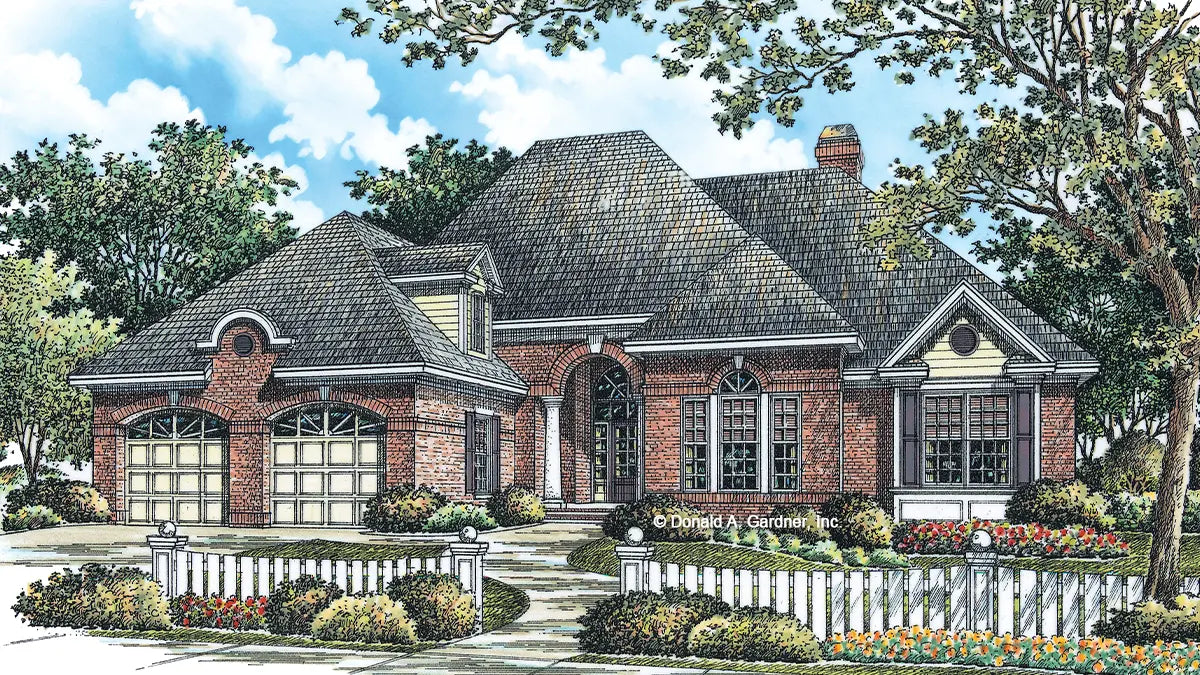 Stunning Palladian windows and columns frame the arched entryway to this impressive brick Traditional home.