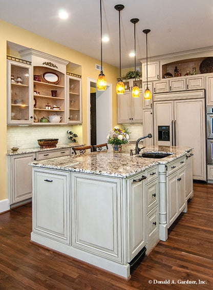 View of the kitchen island with pendant lighting. The Birchwood plan 1239.