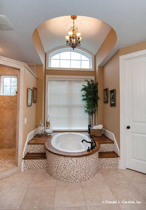 Sitting tub with chandelier above and platform. The Birchwood plan 1239.