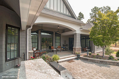 Full rear porch view and stone walkway. The Birchwood plan 1239.