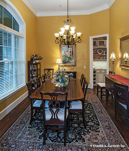 Crown molding ceiling and chandelier in the dining room. The Birchwood plan 1239.