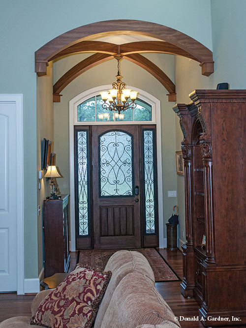 Arched stained wood beams in the foyer. The Birchwood plan 1239.