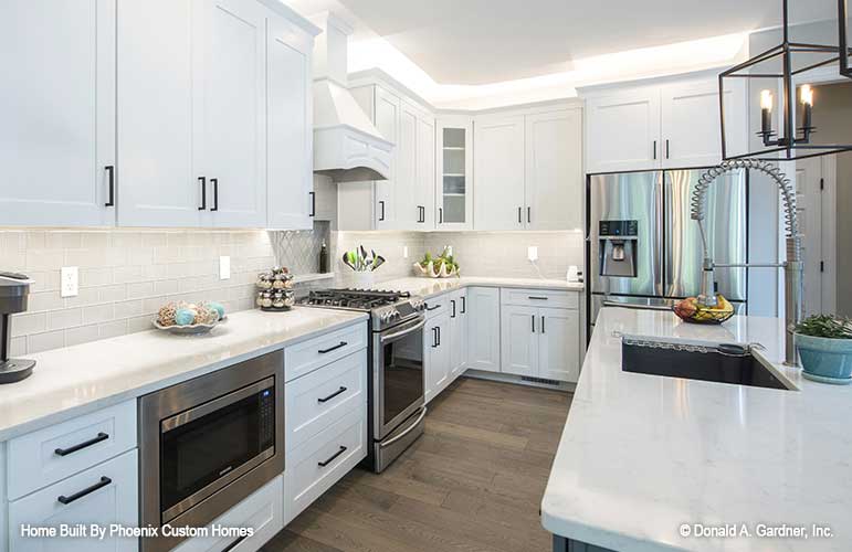 Perfectly spaced out appliances in this kitchen with the sink in the island and microwave built into the cabinets. Blarney plan 1424 