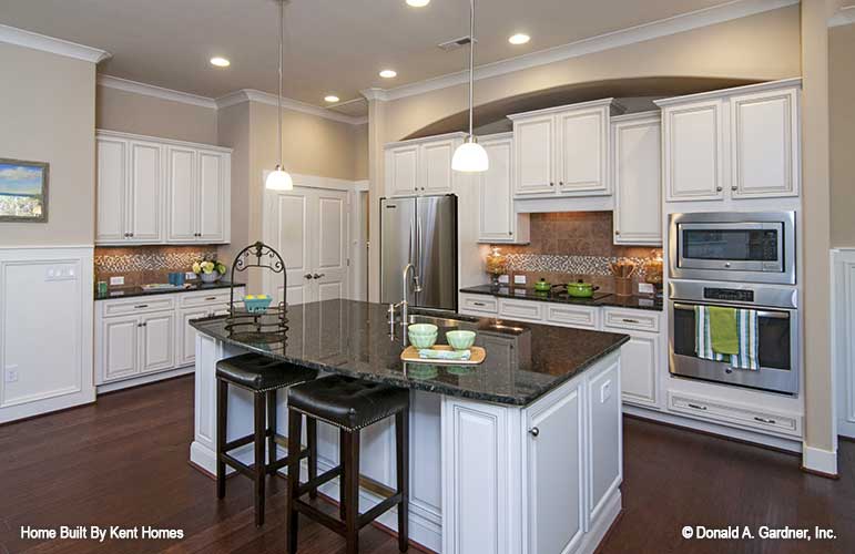 Kitchen with island of cottage house plan 1302 The Bluestone