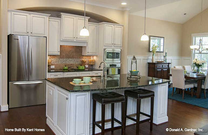 Kitchen picture with sink in island and bar seating of cottage house plan 1302 The Bluestone