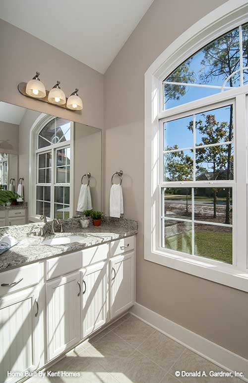 Master bathroom with large windows pictured of cottage house plan 1302 The Bluestone