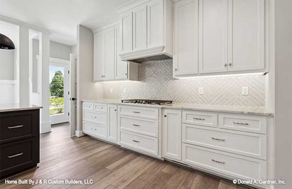 White cabinets and tile backsplash in the kitchen. The Brielle plan 1233.