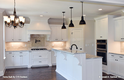 Beautiful kitchen with an island and bar seating. The Brogan plan 947.