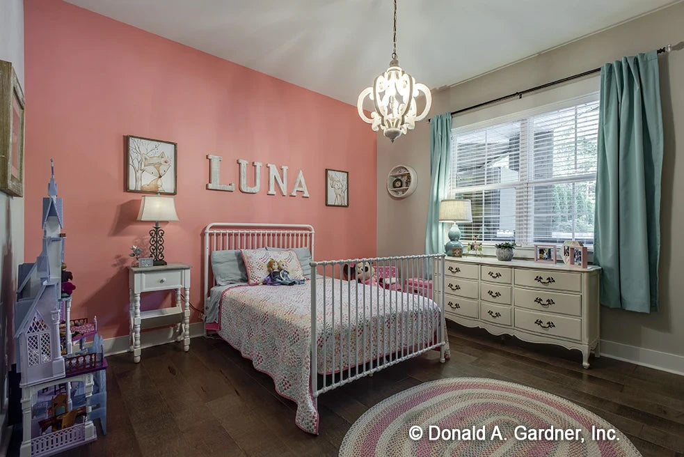 Secondary bedroom with accent colored wall, large window