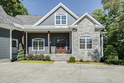 View of the front of the house showing the porch, stone work along with board & batten siding