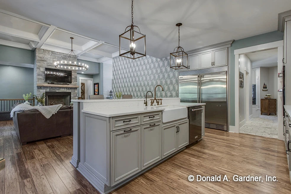 Kitchen with stainless steel appliances and elaborate molding on the cabinets