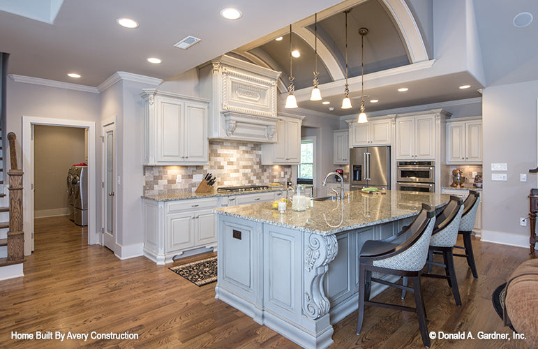 This is a picture of the open and roomy kitchen of the traditional house plan 1141 The Calypso