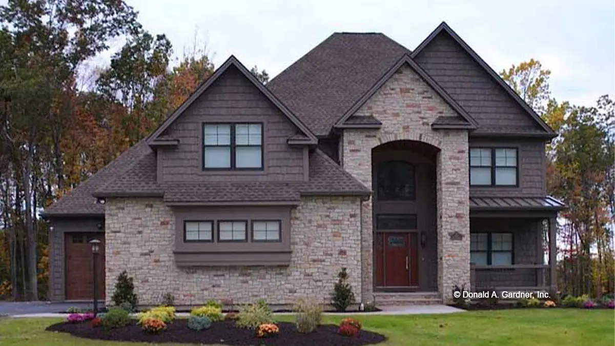 Spacious stone house with brick siding, nestled in a picturesque setting.