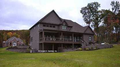 Large house featuring a generous porch and yard in the back.