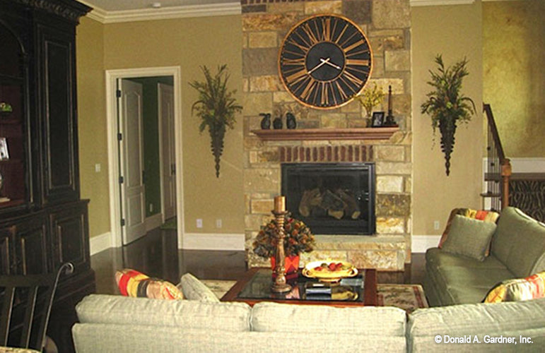 Floor to ceiling stone fireplace in the entertainment room. The Capistrano plan 1227.