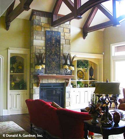 Wood-stained beams on the ceiling in the great room. The Capistrano plan 1227.