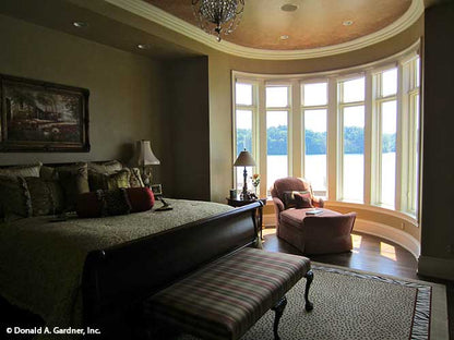 Curved walls with windows in the sitting area in the master bedroom. The Capistrano plan 1227.