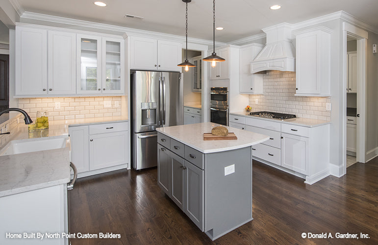 This is a kitchen with island picture of the front of one story house plan 1180 The Carinthia