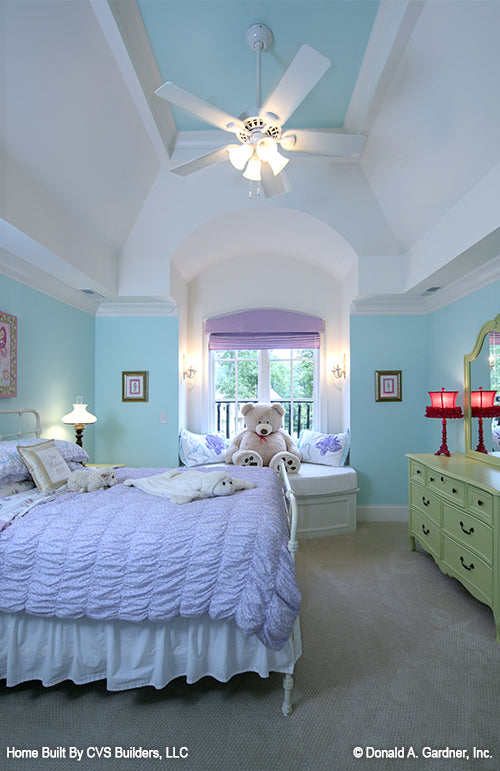 Tray ceiling and window bench seating in a blue bedroom. The Carrera plan 1178.