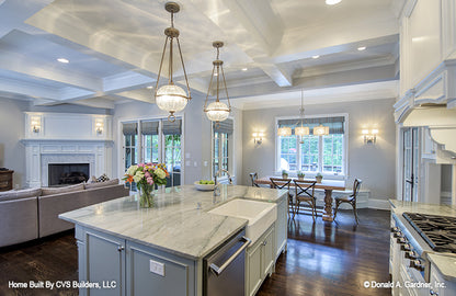 Kitchen island with a farmhouse sink. The Carrera plan 1178.