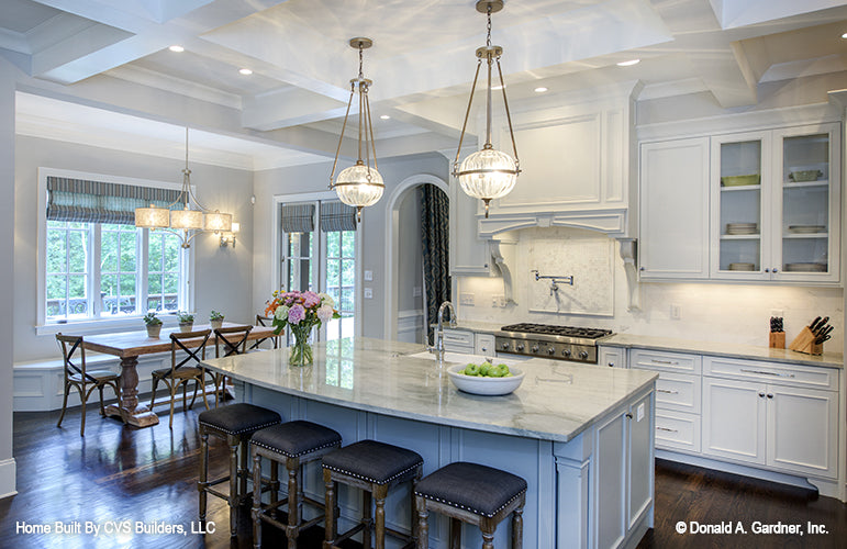 Seating at the kitchen island with pendant lighting above. The Carrera plan 1178.