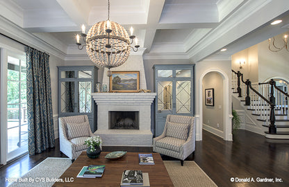 White brick fireplace and mantel in the living room. The Carrera plan 1178.