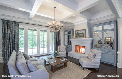 Chandelier and recessed lighting in the great room. The Carrera plan 1178.