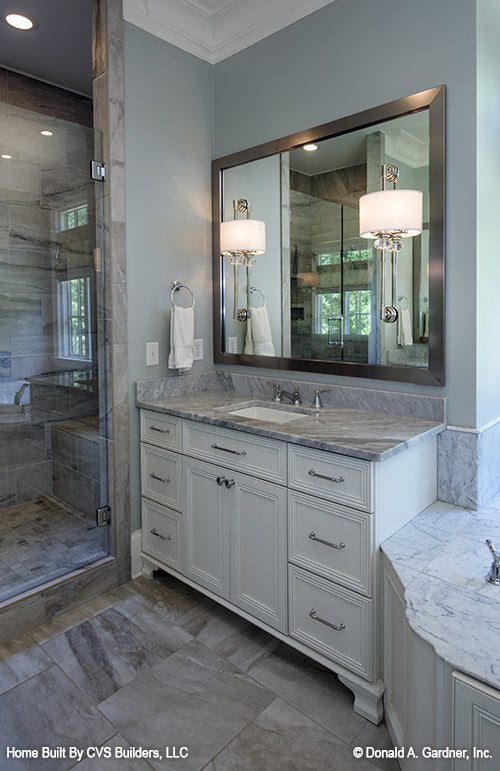 Single sink vanity next to the walk-in shower in the master bathroom. The Carrera plan 1178.